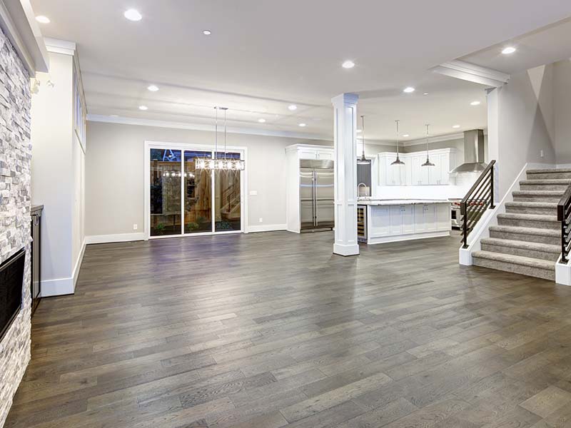 Open-concept living and kitchen area with luxury laminate flooring installed by Orange Cat Flooring in Atlanta, GA.