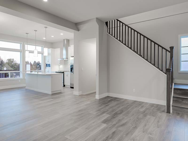 Modern open-concept kitchen and living area featuring newly installed laminate flooring by Orange Cat Flooring in Atlanta, GA.