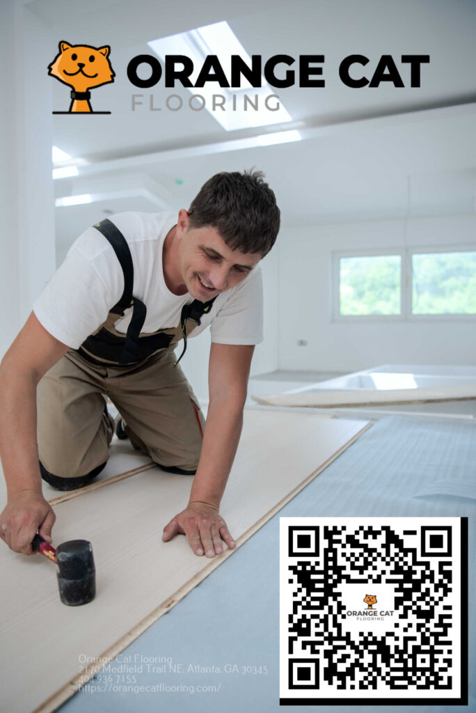 A flooring professional installing laminate flooring with a mallet in a bright, modern room.